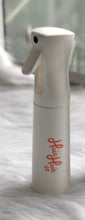 Load image into Gallery viewer, A white curly spray mist bottle designed for hair use, displaying the brand name 'Huia' on its side.